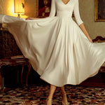Elegante vestido de falda grande blanca de longitud media con cuello en V